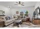 Comfortable living room with plush sofa, natural light, and modern decor for relaxation and entertainment at 13 Toplanders Ter, Gibsonville, NC 27249