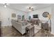 Inviting living room with a neutral color scheme, stylish furnishings, and ample natural light at 13 Toplanders Ter, Gibsonville, NC 27249