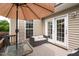 Relaxing back deck with comfortable seating, a shade umbrella, and easy access to the home at 1428 White Opal Dr, Knightdale, NC 27545