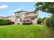 Expansive backyard with a deck, lush grass, and mature trees, ideal for outdoor activities at 1428 White Opal Dr, Knightdale, NC 27545