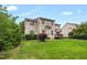 Expansive backyard with a wooden deck, lush lawn, and mature landscaping providing a private outdoor retreat at 1428 White Opal Dr, Knightdale, NC 27545