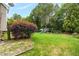 Large, green backyard featuring a playset, garden bed, and vibrant landscaping for outdoor enjoyment at 1428 White Opal Dr, Knightdale, NC 27545