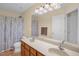 Well-lit bathroom with double sinks, a large mirror, and a shower/tub combination for convenience at 1428 White Opal Dr, Knightdale, NC 27545