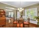 Inviting dining area with a chandelier, hardwood floors, and glass table with seating for a comfortable meal at 1428 White Opal Dr, Knightdale, NC 27545