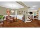 The open-concept dining area boasts a classic chandelier and rich hardwood flooring, perfect for entertaining at 1428 White Opal Dr, Knightdale, NC 27545