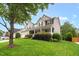 Traditional home with a lush lawn, mature tree, two-story profile, and covered front porch with white columns at 1428 White Opal Dr, Knightdale, NC 27545