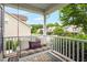 Cozy front porch with a swing adorned with pillows, offering a relaxing view of the neighborhood at 1428 White Opal Dr, Knightdale, NC 27545
