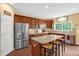 Charming kitchen features stainless steel appliances, an island with seating, and natural light at 1428 White Opal Dr, Knightdale, NC 27545