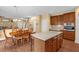 Well-designed kitchen featuring an island with seating, with stairs and dining area view at 1428 White Opal Dr, Knightdale, NC 27545