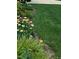 Well-manicured lawn and garden bed featuring a variety of colorful flowers, enhancing curb appeal at 1428 White Opal Dr, Knightdale, NC 27545