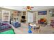 Spacious living room featuring plush seating, a ceiling fan, and a play area perfect for children at 1428 White Opal Dr, Knightdale, NC 27545