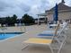 Community pool area featuring lounge chairs, umbrellas, tables and chairs near the pool at 1428 White Opal Dr, Knightdale, NC 27545
