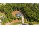 Aerial view of home with mature trees, long driveway, large lawn in wooded neighborhood at 147 Gentry Dr, Pittsboro, NC 27312
