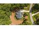 Aerial view of house, showing the roofline, driveway, mature trees and surrounding landscaping at 147 Gentry Dr, Pittsboro, NC 27312