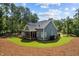 Well-manicured lawn and screened-in back porch highlight this home's exterior appeal at 147 Gentry Dr, Pittsboro, NC 27312