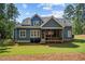 Charming home featuring a screened porch and well-maintained backyard with mature trees at 147 Gentry Dr, Pittsboro, NC 27312