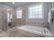 Elegant bathroom features a glass enclosed shower and separate soaking tub at 147 Gentry Dr, Pittsboro, NC 27312