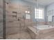 Elegant bathroom features a glass enclosed shower and separate soaking tub at 147 Gentry Dr, Pittsboro, NC 27312