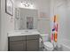 Charming bathroom features a single vanity, decorative mirror, and bathtub with a colorful curtain at 147 Gentry Dr, Pittsboro, NC 27312