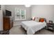 Comfortable bedroom with a bed, large window, and a dark wood dresser, creating a relaxing atmosphere at 147 Gentry Dr, Pittsboro, NC 27312