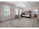 Cozy bedroom featuring a bunk bed, rug, desk, and natural light from large windows at 147 Gentry Dr, Pittsboro, NC 27312