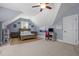 Charming bedroom with an angled ceiling, featuring a cozy bed and quaint desk with seating at 147 Gentry Dr, Pittsboro, NC 27312