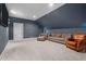 Large bonus room with blue walls, carpet flooring, recessed lighting, and comfortable seating arrangement at 147 Gentry Dr, Pittsboro, NC 27312