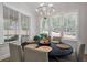 This bright dining area has a round black table, six upholstered chairs and a modern chandelier at 147 Gentry Dr, Pittsboro, NC 27312