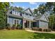 Charming two-story home with blue siding, stone accents, landscaped yard and American flag at 147 Gentry Dr, Pittsboro, NC 27312