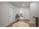 Well-lit hallway with hardwood floors, white trim, and doorways leading to other rooms at 147 Gentry Dr, Pittsboro, NC 27312