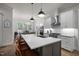 The kitchen features an island with seating and modern pendant lighting, and it adjoins the dining area at 147 Gentry Dr, Pittsboro, NC 27312