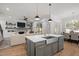 Open concept living spaces featuring a kitchen island with seating, a living room with a fireplace, and a dining area at 147 Gentry Dr, Pittsboro, NC 27312