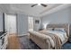 Inviting main bedroom with a large bed, hardwood floors, neutral colors, and ample natural light at 147 Gentry Dr, Pittsboro, NC 27312
