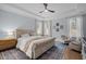 Serene main bedroom with a large bed, sitting area, hardwood floors, and tray ceiling at 147 Gentry Dr, Pittsboro, NC 27312
