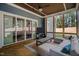 Inviting sunroom featuring an open view, comfortable seating, and wood flooring with an area rug at 147 Gentry Dr, Pittsboro, NC 27312