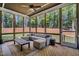 Bright screened-in porch with plush outdoor seating, a wood paneled ceiling, and a scenic wooded view at 147 Gentry Dr, Pittsboro, NC 27312