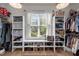 Well-organized walk-in closet with built-in shelves, hanging rods, and shoe storage at 147 Gentry Dr, Pittsboro, NC 27312