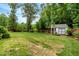 Large, private backyard with an outbuilding and a wood fence border at 150 Teal Dr, Youngsville, NC 27596