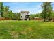 Large backyard with a wood fence, lush lawn, and a well-maintained lawn at 150 Teal Dr, Youngsville, NC 27596