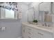Bright bathroom featuring double sinks, modern vanity, and a large window at 150 Teal Dr, Youngsville, NC 27596