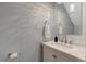 Stylish powder room with a white vanity, rectangle mirror, modern fixtures, and beautiful wall texture at 150 Teal Dr, Youngsville, NC 27596