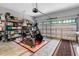 Organized garage with storage shelves, workout equipment, and a patterned rug, and a door at 150 Teal Dr, Youngsville, NC 27596