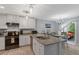 Bright kitchen with granite countertops, stainless steel sink, white cabinetry, and modern appliances at 150 Teal Dr, Youngsville, NC 27596