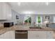 Eat-in kitchen featuring granite countertops, stainless steel appliances, white cabinets, and an island at 150 Teal Dr, Youngsville, NC 27596