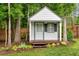 Charming backyard shed with a covered porch, window, and nearby trees at 150 Teal Dr, Youngsville, NC 27596