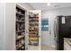 Walk-in pantry with door organizers, shelving with food, and a refrigerator at 150 Teal Dr, Youngsville, NC 27596