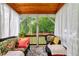 Relaxing screened porch with comfortable seating and a view of the lush backyard at 150 Teal Dr, Youngsville, NC 27596