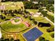 Aerial view highlighting the community's sports fields, including baseball diamonds and a football field at 158 Vaughan Farms Drive Dr, Angier, NC 27501