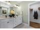 Elegant bathroom with double vanity, modern lighting, and a walk-in closet for ample storage at 158 Vaughan Farms Drive Dr, Angier, NC 27501