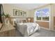 Cozy bedroom with neutral decor, plush bedding, and a view of the outdoors through a large window at 158 Vaughan Farms Drive Dr, Angier, NC 27501